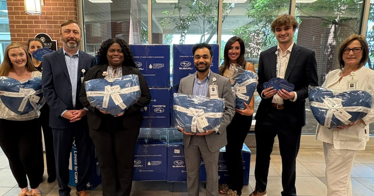 Wyatt Johnson Subaru with donations for Tennova Healthcare patients.