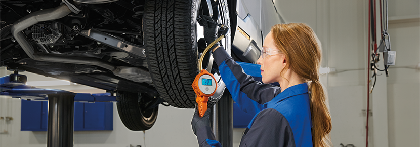A Subaru technician checking tire pressure. | Wyatt Johnson Subaru in Clarksville TN