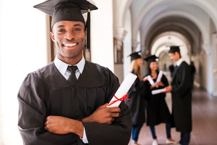 college graduate holding his diploma | Wyatt Johnson Subaru in Clarksville TN