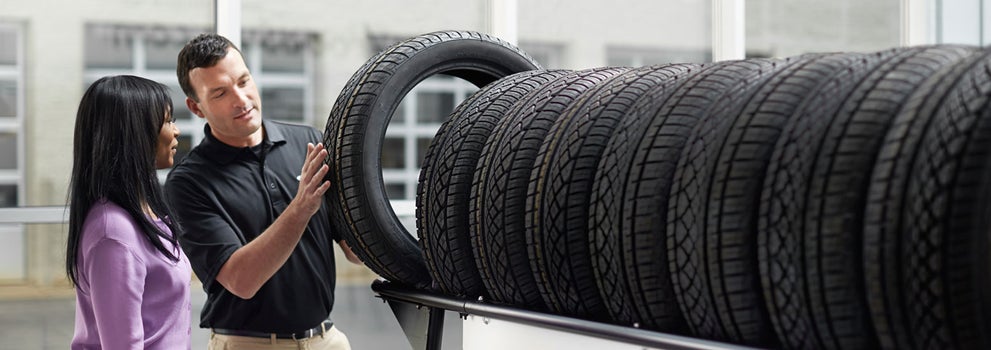 Subaru service representative showing customer a tire. | Wyatt Johnson Subaru in Clarksville TN